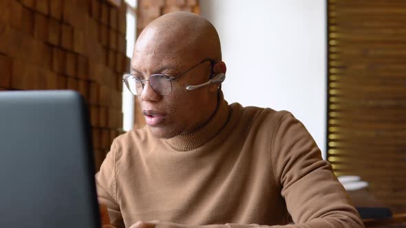 An African American Man is Negotiating Remotely Via Video Chat