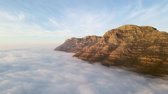 Aerial view of False bay covered in low cloud sunrise, Simonstown, Cape Town, South Africa.