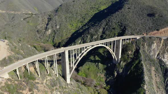 Aerial view of the picturesque arch bridge standing over the canyon. 