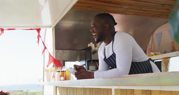 African american man wearing apron ordering food at the food truck