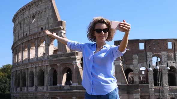 Young Woman Taking Selfie Using Smartphone At Famous Tourist Attraction