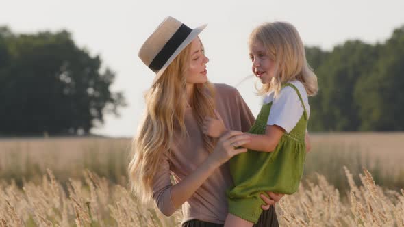 Portrait Young Beautiful Mother Blonde Woman in Straw Hat Stands in Wheat Field Holding Little