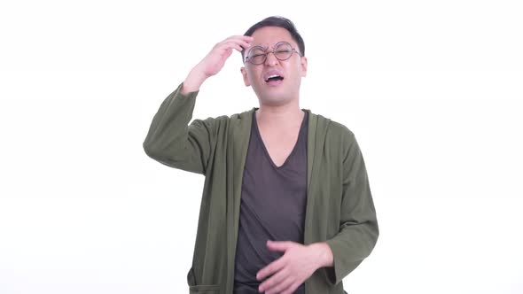 Stressed Japanese Man with Eyeglasses Getting Bad News