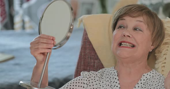 Senior Beautiful Woman Checking Her Look and Smiling in Front of Mirror, Elderly Female Retired