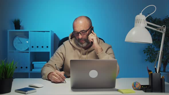 Businessman Talking on Mobile Phone in Board Room