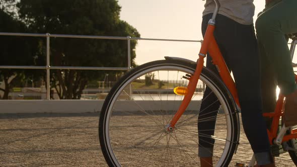 Couple interacting with each other in cycle at beach 4k