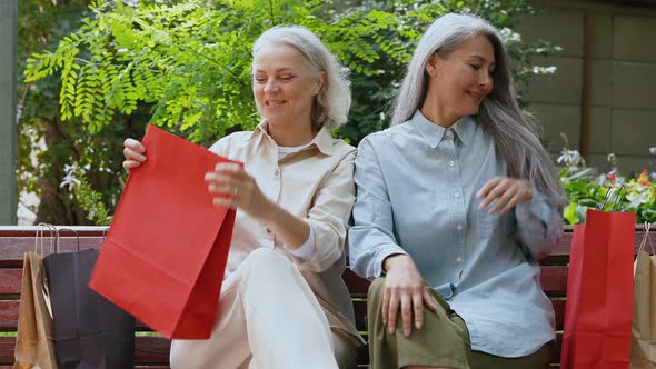 Two senior women doing shopping