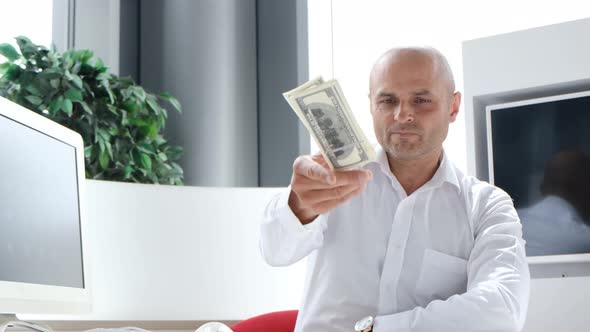 Successful Businessman Throws a Wad of Money on the Table and Looks at the Camera