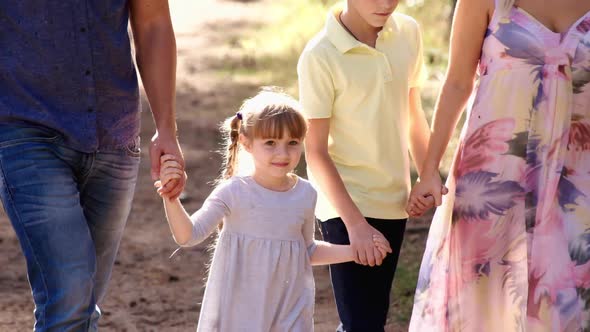 Family is Walk on Green Grass in Natural Park