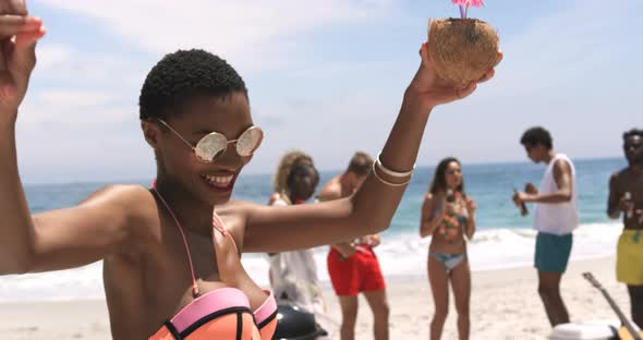 Front view of African American woman dancing on the beach 4k