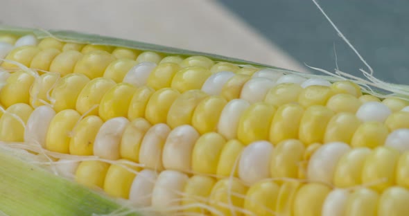 Beautiful macro close up pan across a freshly picked, ripe corn on the cob