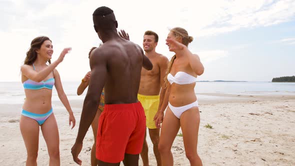 Happy Friends Making High Five on Summer Beach 