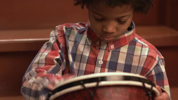 Young Afro Drummer on Stairs.