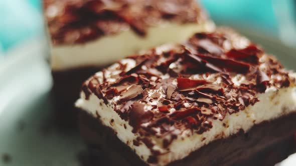 Close Up on Chocolate Pieces of Layered Cake. Sprinkled with Milk Chocolate
