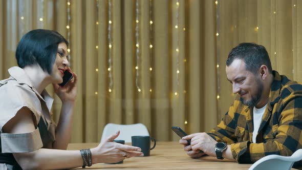 Young Couple of Modern People Spend Time Together with Mobile Phone