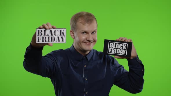 Joyful Man Showing Two Black Friday Inscription Notes, Smiling Looking Satisfied with Low Prices