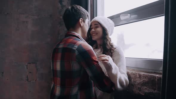 Close Up of Young Beautiful Blonde Woman Hugging Man Holding Christmas Present.