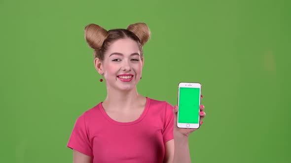 Girl Advertises the Phone. Green Screen. Slow Motion