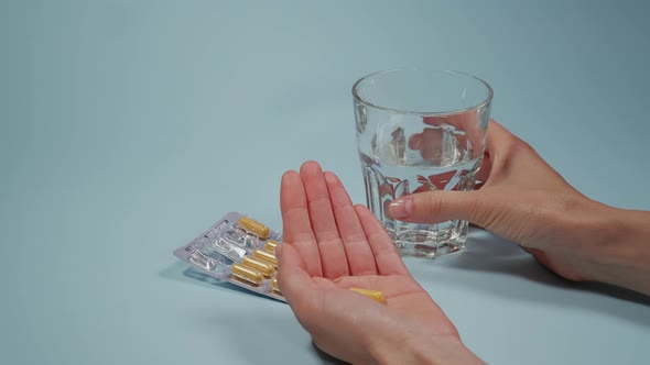 Hands pushing out a pill from blister packaging