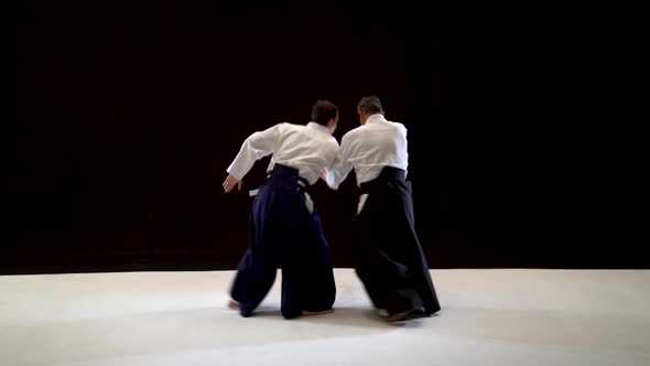 Two Aikido Masters Technique Demonstration on Black and White Studio.