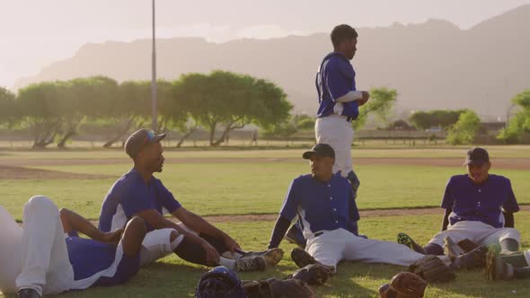 Baseball players sitting on a ground