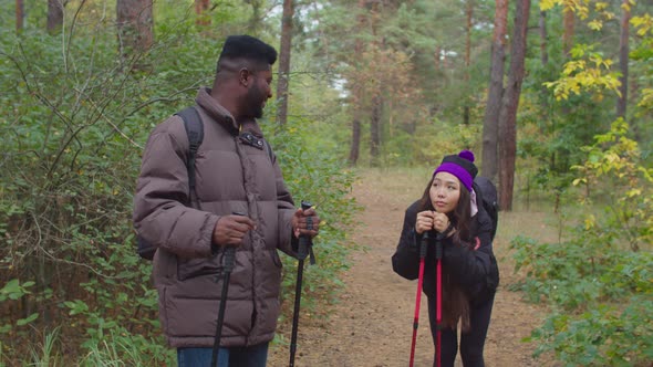 African Man Encouraging Tired Woman During Hike