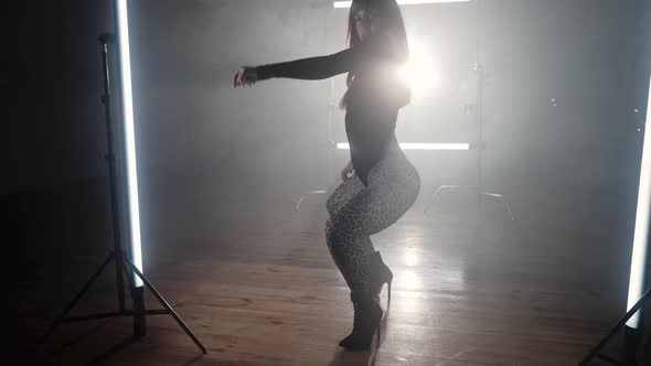 Woman Dancer in Smoky Room Dancing Beautifully and Seductively to Beat of Music