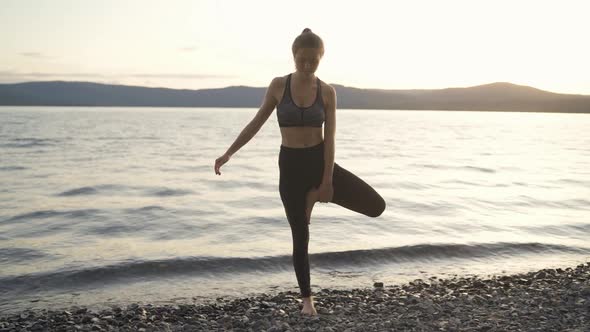 Young Woman Silhouette Practice Yoga at Summer Sunset Near Lake