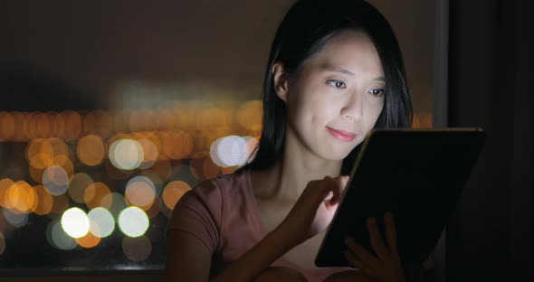 Woman use of mobile phone at night