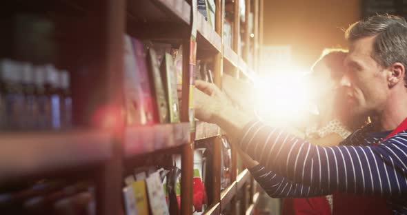 Staff arranging grocery items on shelf