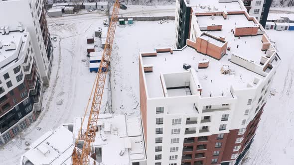 Aerial view of a construction site covered with snow.