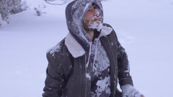 The man buried in the snow is forced to his feet.