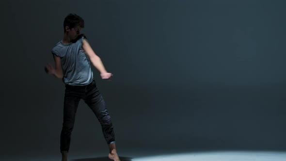 Emotional Performance of Man Dancing Modern Ballet on Gray Studio Background