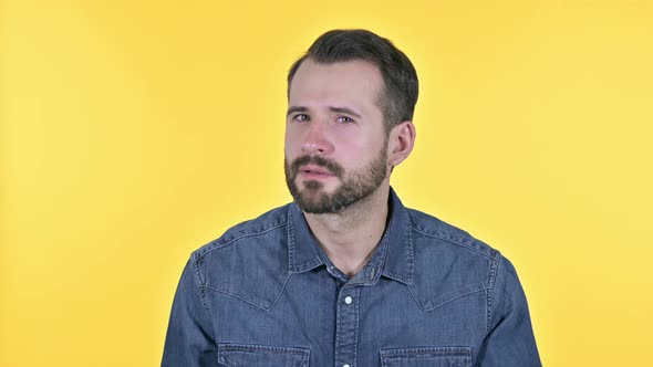 Curious Beard Young Man Listening To Something, Yellow Background