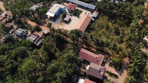 Aerial overview of school buildings and community during a sunny breezy day in Battambang Cambodia