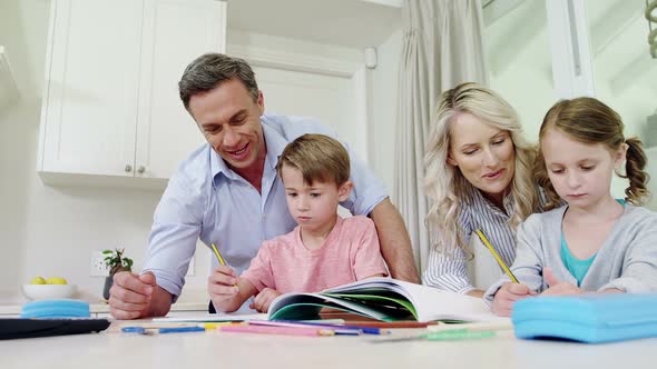 Parents assisting kids in doing homework in living room