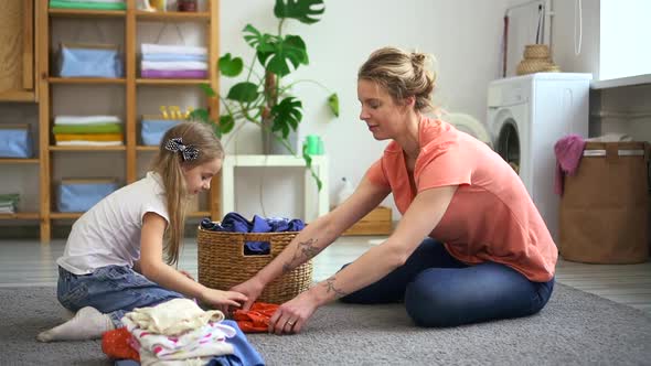 Woman Housewife Do Laundry Housework with Her Smiling Daughter Spbd