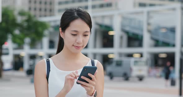 Woman use of mobile phone in city