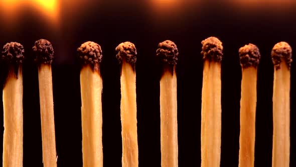 Burning matches on a black background.