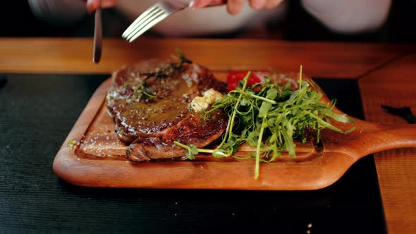 Succulent Steak with Vegetables on Wooden Board