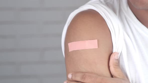 Adhesive Bandage on Young Man's Arm