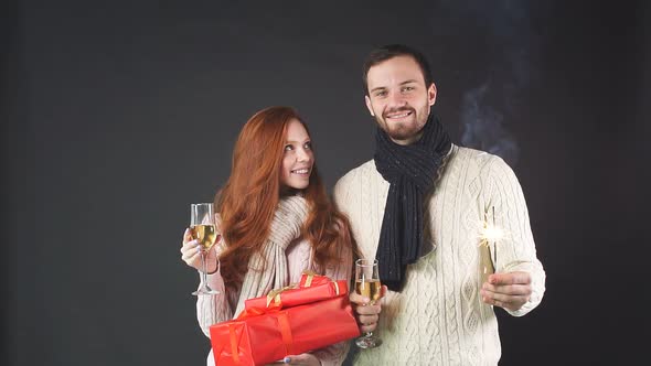 Happy Family Holding Champagne Glasses and Sparklers for New Year.