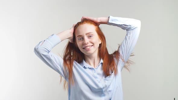 Portrait of Young Beautiful Redhead Girl Smiling Looking at Camera. Slow Motion.