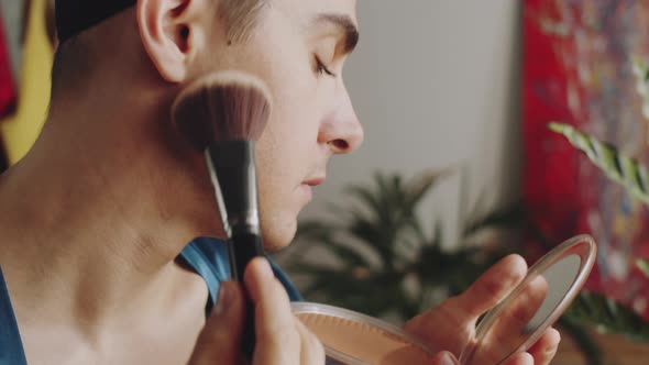 Transgender Man Applying Powder with Brush