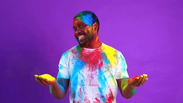 Afro American Man Celebrate Holi Festival in Violet Studio Background