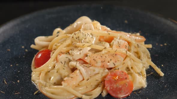 Serving Pasta in Restaurant on Black Background