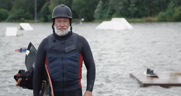 Wakeboarder, Portrait of Adult Man, Sportsman Stands Near the Lake, Looks at the Camera