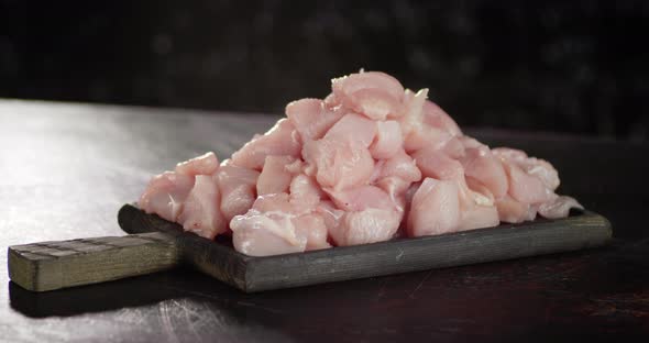 A Bunch of Raw Chopped Chicken Fillet Rotates Slowly.