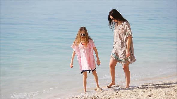 Beautiful Mother and Daughter at the Beach Enjoying Summer Vacation