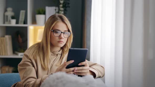 Woman Eyeglasses Using Tablet Couch